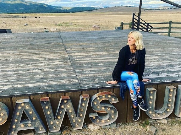 Photos of Michelle Beisner-Buck. She is wearing Black shoes, blue pants and black  t-shirt and pants. 